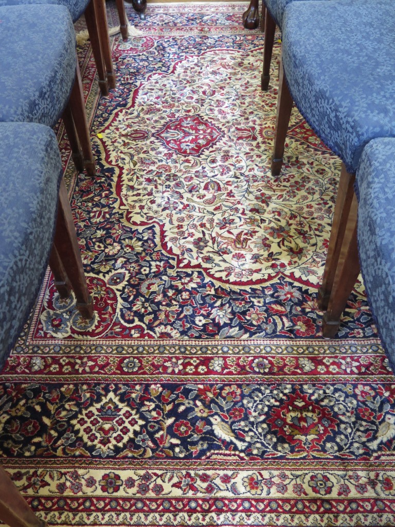 A Kashmir design carpet, the central red medallion on an ivory field, filled with flowers and