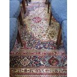 A Kashmir design carpet, the central red medallion on an ivory field, filled with flowers and