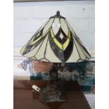 An Art Nouveau style bronze effect table lamp, with lead glazed shade 49cm high