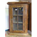 A George III style walnut hanging corner cupboard, with panelled glass door 53cm wide 76cm high