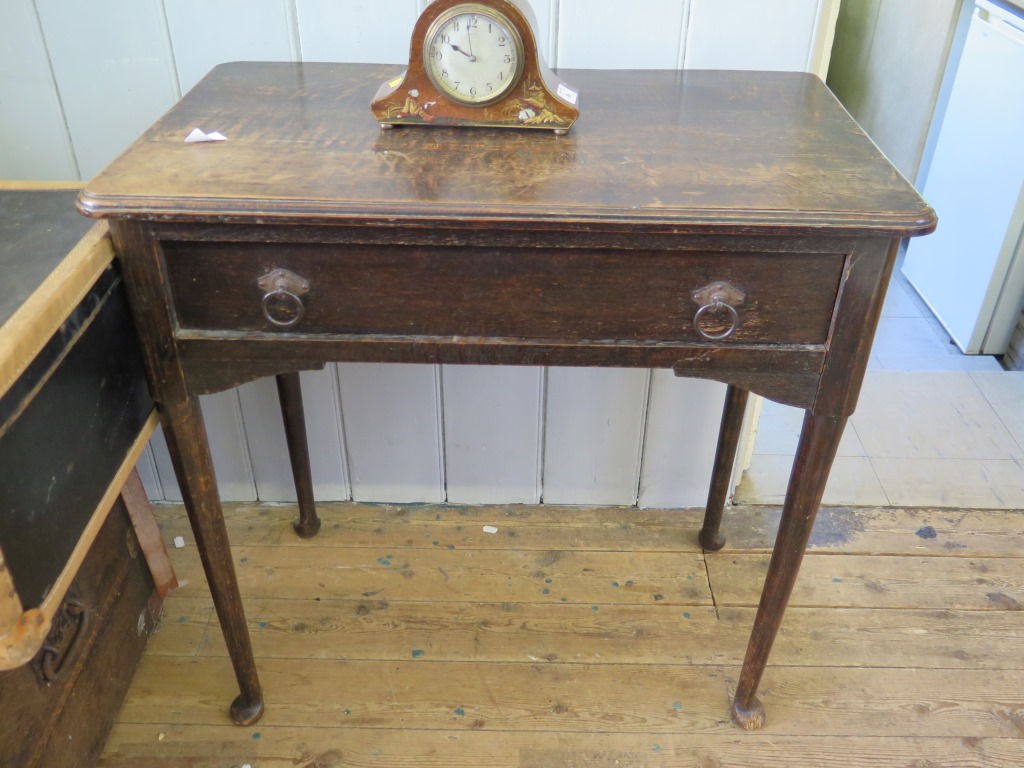 A George II style oak side table, the top with moulded edge over a frieze drawer on turned