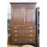 An early 19th century mahogany linen press, the cavetto moulded cornice over a pair of panelled