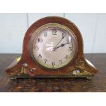 A 1920s mahogany mantel clock retailed by Asprey, London, the silvered engine turned dial within a