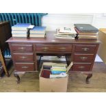 An Edwardian mahogany lady's writing desk, the central drawer and kneehole flanked by three
