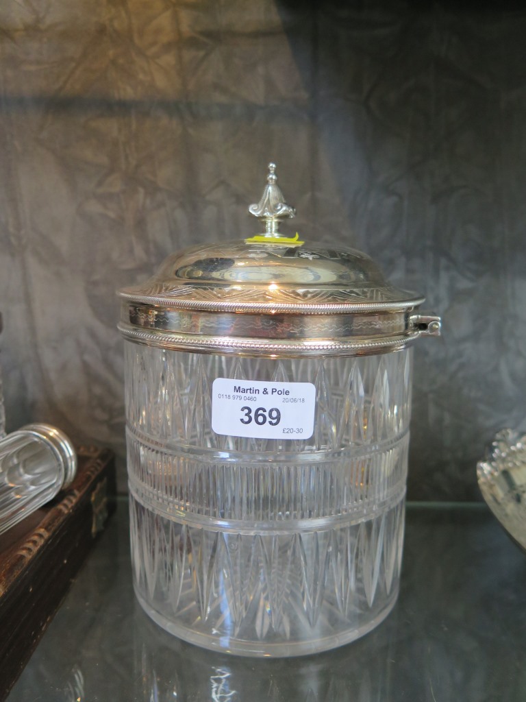 A cut glass bon bon / biscuit barrel with silver plated top