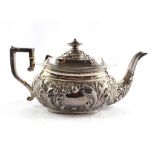 A Victorian silver teapot highly decorated in relief, Birmingham 1899