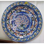 A large Turkish Iznic style Kutahya pottery wall hanging charger 42cm diameter signed by decorator