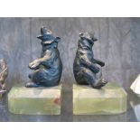 A pair of onyx and bronze bookends in the form of seated bears, 15cm high