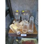 A collection of vanity bottles with plated lids, a silver topped vanity jar and a cased set of