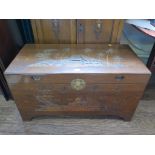 A Far Eastern camphorwood chest, carved with tree and houses 101cm wide, 50cm deep, 55cm high