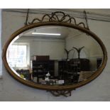 An oval giltwood wall mirror, with ribbon swags 78cm x 58cm