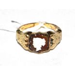 A 14 carat gold ring set with a stone cameo