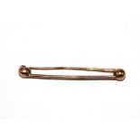 A gold colour metal tie pin