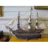 A scale model of H.M.S. Victory, in full sail with guns at the ready 101cm long, 76cm high