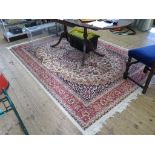 *A Keshan style carpet with allover floral design on a sand colour field and red border, 200cm x