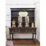 A late 17th century oak dresser and rack, the stepped two tier rack with later parts, over a dresser