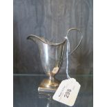 A silver cream jug of helmet form on square base, Sheffield 1909