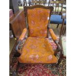 An early Victorian open armchair with upholstered back and seat on lotus carved legs