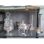 A silver plated tea pot, a pair of plated candlesticks and a plated cruet and a large plated tray