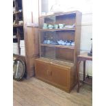 An oak Minty stacking bookcase, the three tiers of shelves with sliding glass doors above a pair