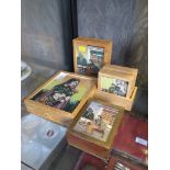 A collection of three boxes and a set of six mats all with coloured gem stone painted scenes of