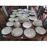 A Clarice Cliff Wilkinson dinner service with blue floral design border including six meat plates,