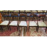A set of five early Victorian dining chairs, the broad top rails above drop in seats on lotus carved
