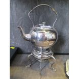 A silver plated bachelor size kettle and burner on three pad feet