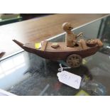 A softwood Kobe automata toy, of a figure in a boat eating, c 1880, 20cm long