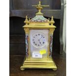 An Edwardian brass and champsleve enamel mantel clock, the caddy top and finials over a silvered