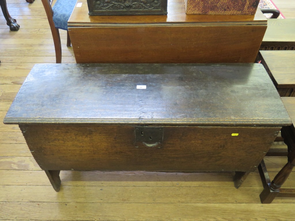 A 17th century planked oak coffer enclosing a candlebox, 103cm wide, 36cm deep, 58cm high