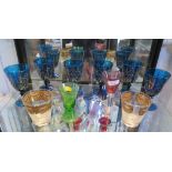 A set of six hand-blown blue glass goblets with gilt scroll decoration, an amber bowl wine glass,