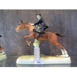 A Beswick figure of a lady riding a horse side-saddle over a fence, 25cm high.