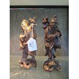 A pair of Chinese carved hardwood figures of sages, 21cm high