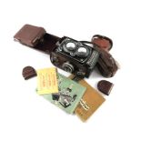 A Rolleiflex 3.5 TLR camera, with Planar 75mm 1:3.5 lens case no. 1756980, with manual, lenses and