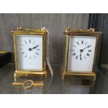 A brass cased carriage clock with white enamel dial together with a similar carriage clock (2)