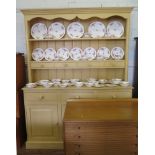 A painted pine dresser and rack, the rack with two shelves and four drawers over three drawers and