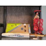 A Japanese silk and bamboo parasol, another parasol, a Japanese doll on stand, and a boxed charm
