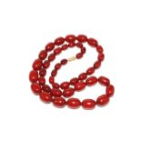 A string of beads resembling cherry amber
