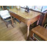 An early Victorian mahogany foldover tea table with broad frieze on ring turned tapering legs 91cm