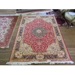 *A Keshan style carpet with black medallion and ivory spandrels on a red field with all over