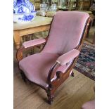 An Early Victorian mahogany armchair, the scrolled upholstered back and open arms on lobed