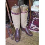 A pair of leather and canvas hobnail riding boots, with boot trees