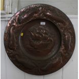 A Newlyn copper charger, the centre depicting a ship in full sail within a fish motif border,