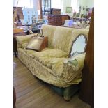 A 1920s upholstered three seat settee on bun feet 200cm