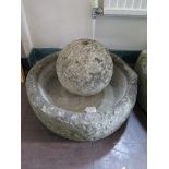 A limestone millstone 47cm diameter, and an ornamental ball