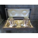 A pair of silver candlesticks in presentation box