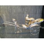 A Chinese coolie pulling a white metal cart containing a cruet