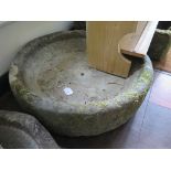 A limestone millstone, 64cm diameter