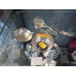 A collection of silver items to include a tea strainer and sifter spoon, a small silver dish, etc
